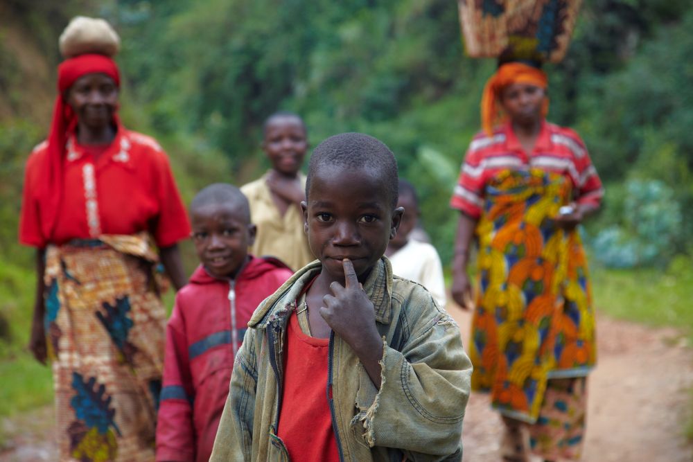 young-boy-in-focus-on-a-rural-path-with-people-wal-