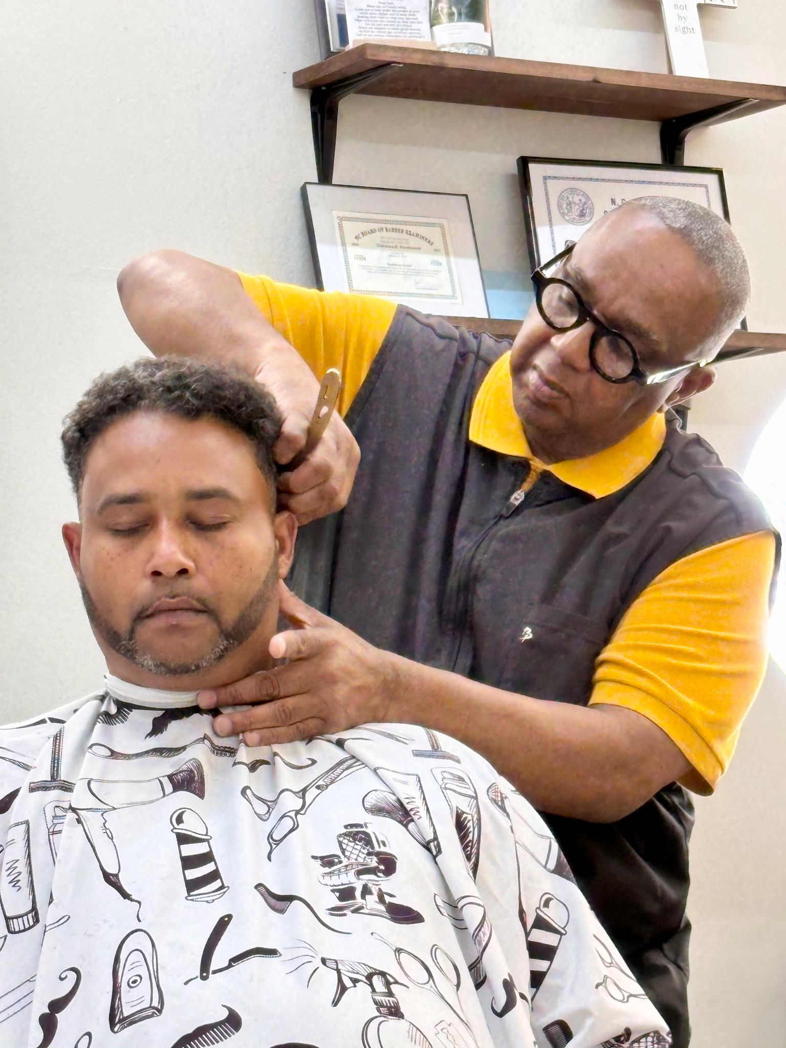 Professional barber giving a haircut at Fade N Up in Knightdale NC